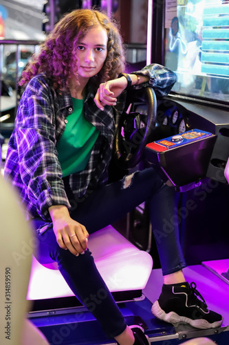 Girl behind the wheel of a driving simulator machine