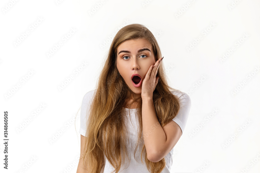 Portrait of young surprised beautiful woman with shocked facial expression on white background Portrait of young surprised beautiful woman with shocked facial expression on white background