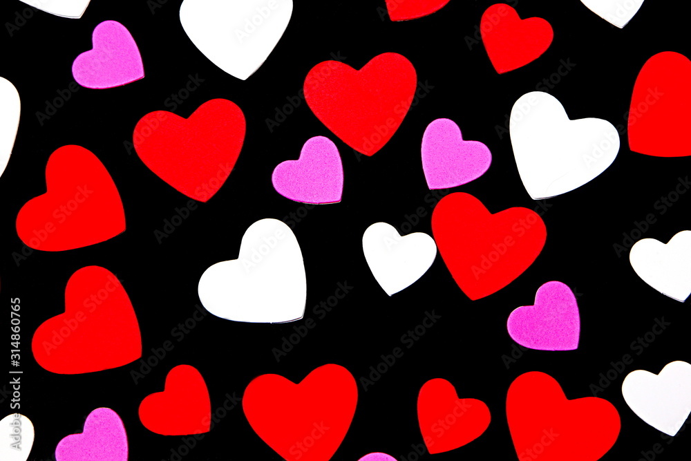 Red, white and purple hearts on a black background. Valentines day concept. Red, white and purple hearts on a black background. Valentines day concept.