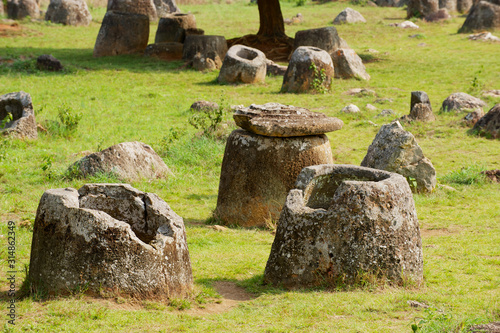 Ancient stone jars in a Plain of Jars (Site #1) near Phonsavan, Xienghouang province, Laos.. photo