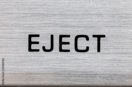 Macro close up photograph of vintage tape machine eject button detail.   photo