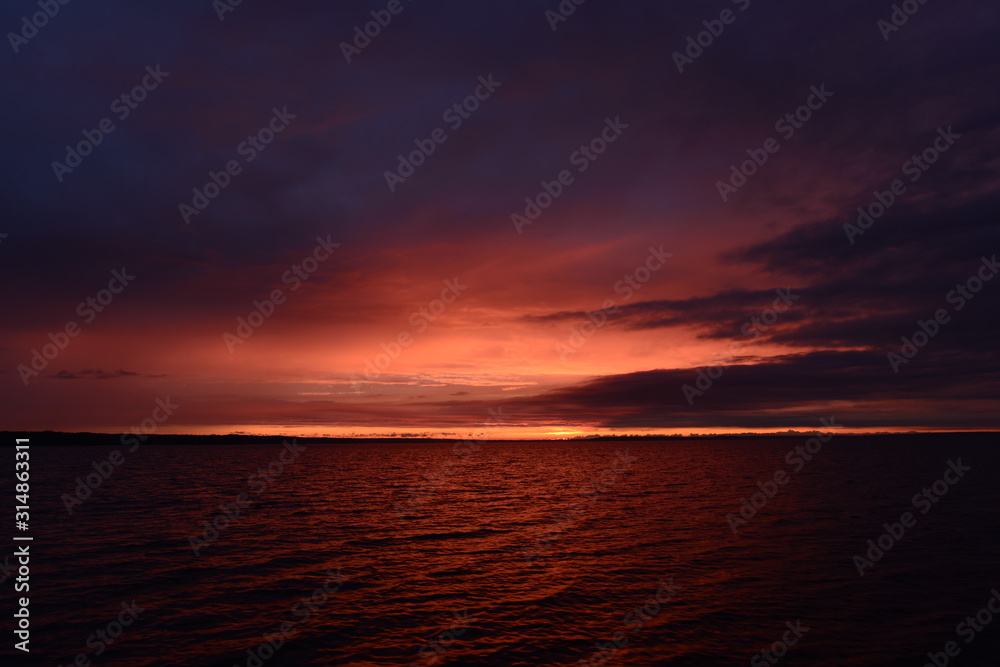 Twilight sky over the lake in bright colors of a sunset