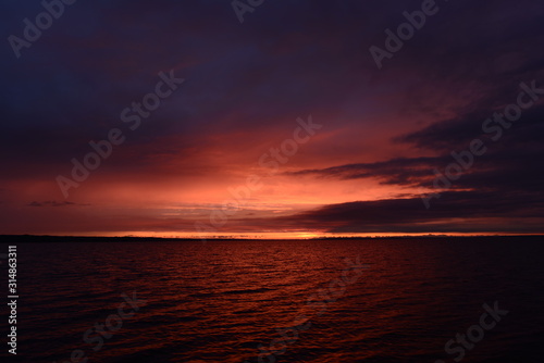 Twilight sky over the lake in bright colors of a sunset