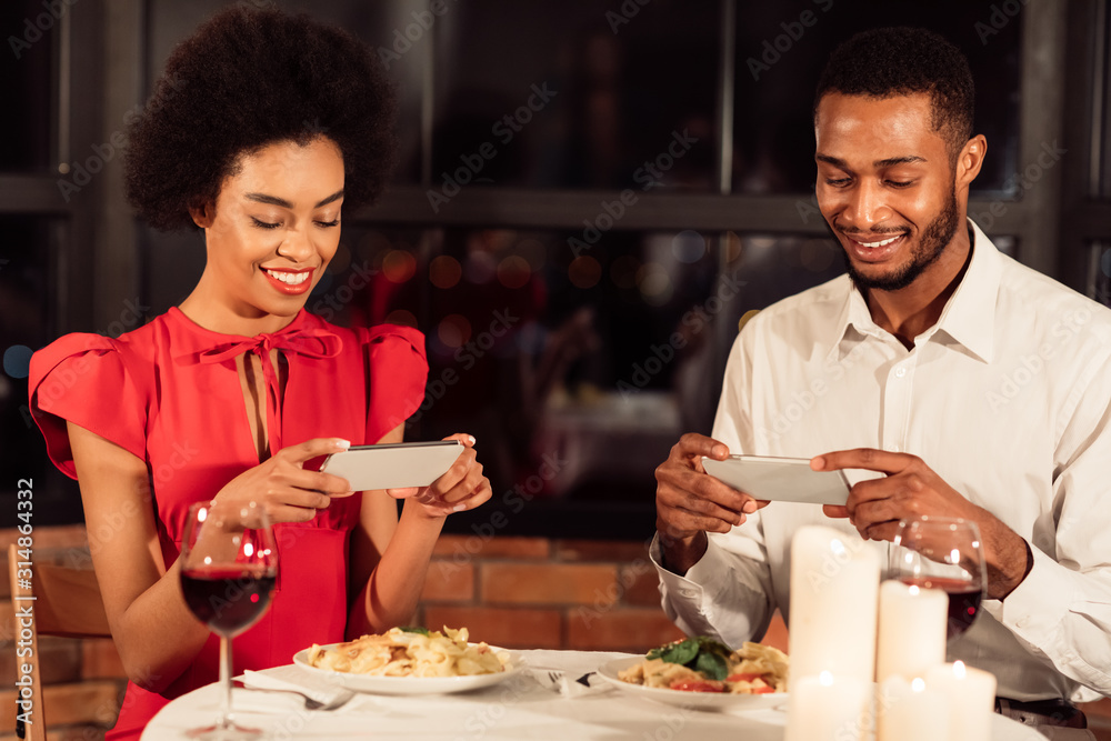 Spouses Taking Photo Of Food Ignoring Each Other During Date