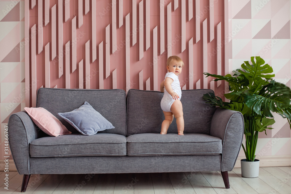 Obraz premium a small child on a grey sofa