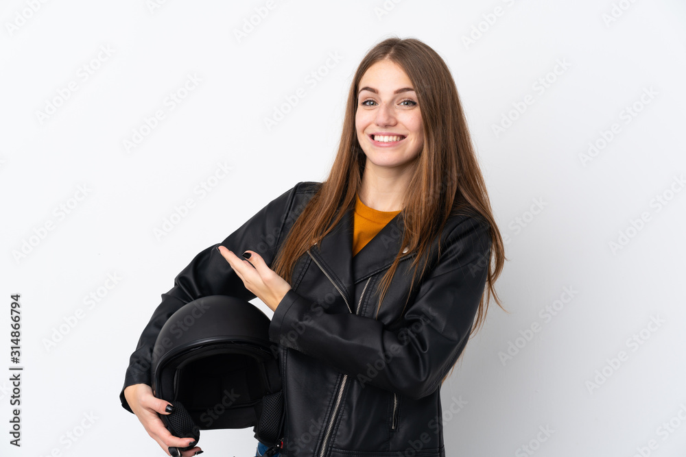 Woman with a motorcycle helmet extending hands to the side for inviting to come Woman with a motorcycle helmet extending hands to the side for inviting to come