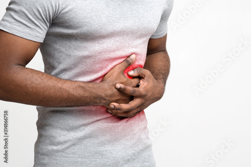 Man with abdominal pain over white background