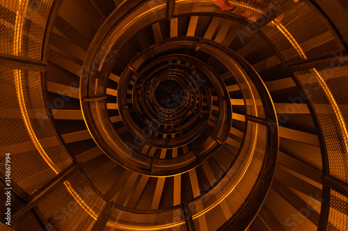 Spiral staircase in the dark with orange light