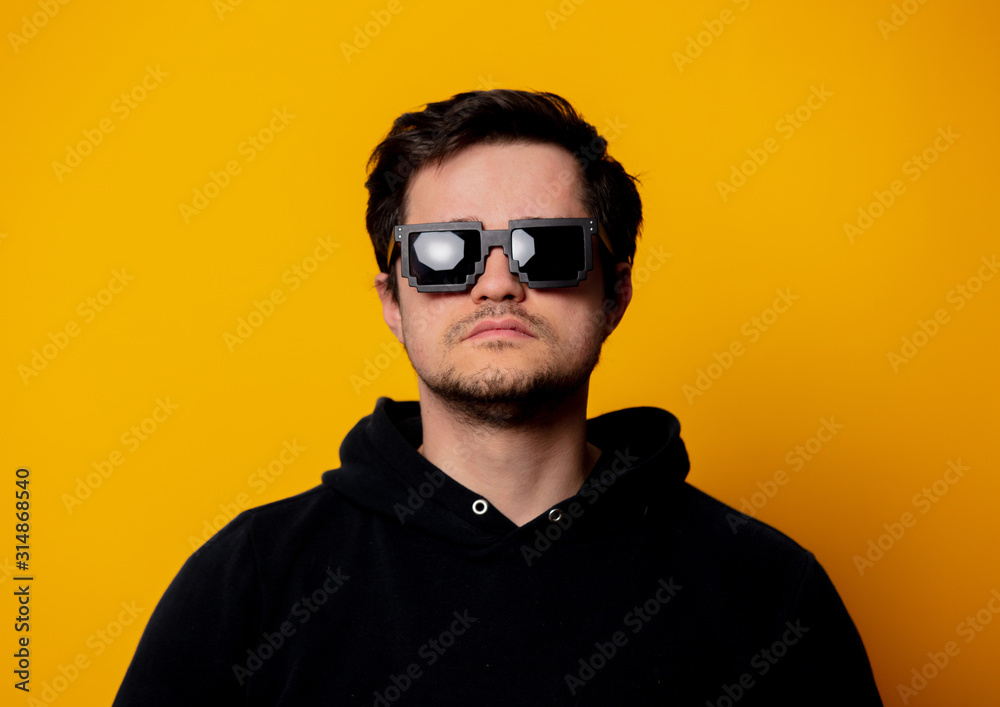 brunette man in sunglasses and black hoodie brunette man in sunglasses and black hoodie