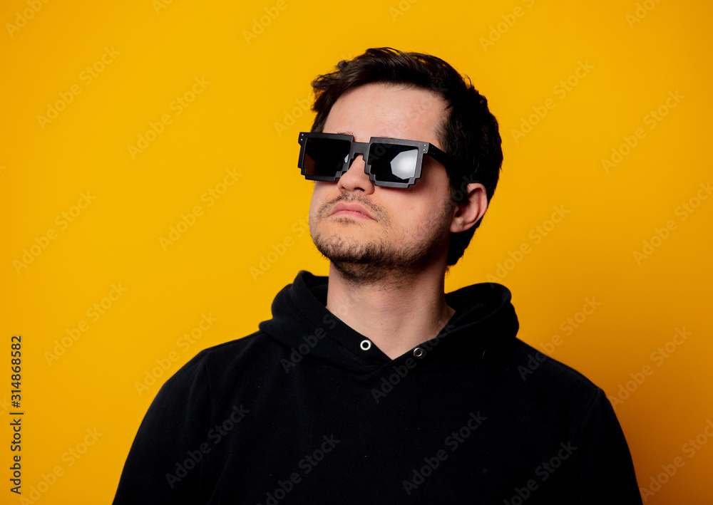 brunette man in sunglasses and black hoodie brunette man in sunglasses and black hoodie
