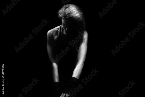 athletic caucasian female sitting on floor black and white photo