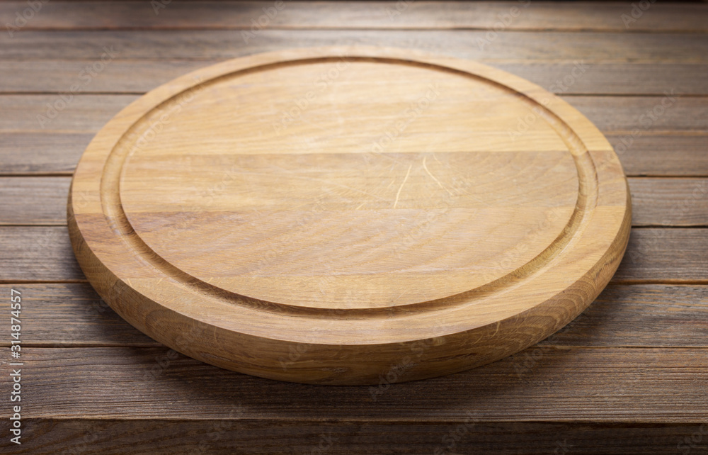 pizza cutting board at rustic wooden plank background