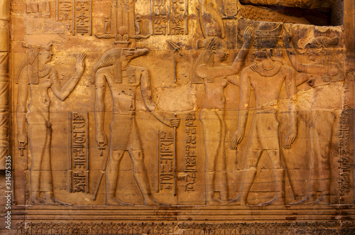 Hieroglyphic carvings on the exterior walls of an ancient egyptian temple