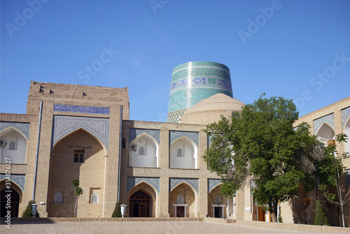 Mohammed Amin Khan Madrassah with Kalta Minor minaret in the backkground. Khiva, Uzbekistan.