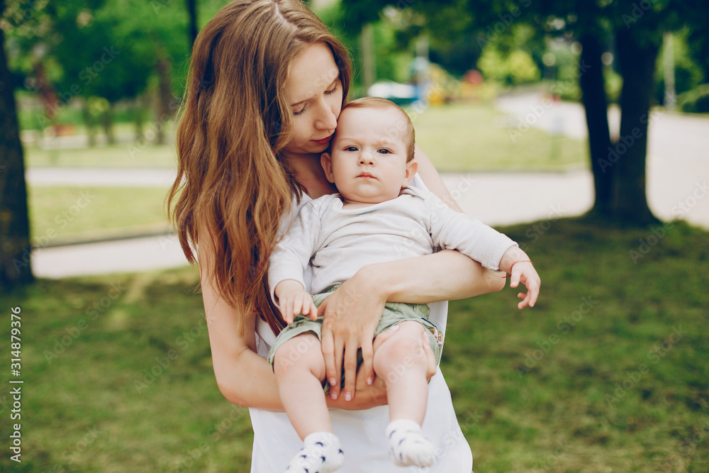 Mother with a baby. Walking in the park. Family relationship. Mother with a baby. Walking in the park. Family relationship.