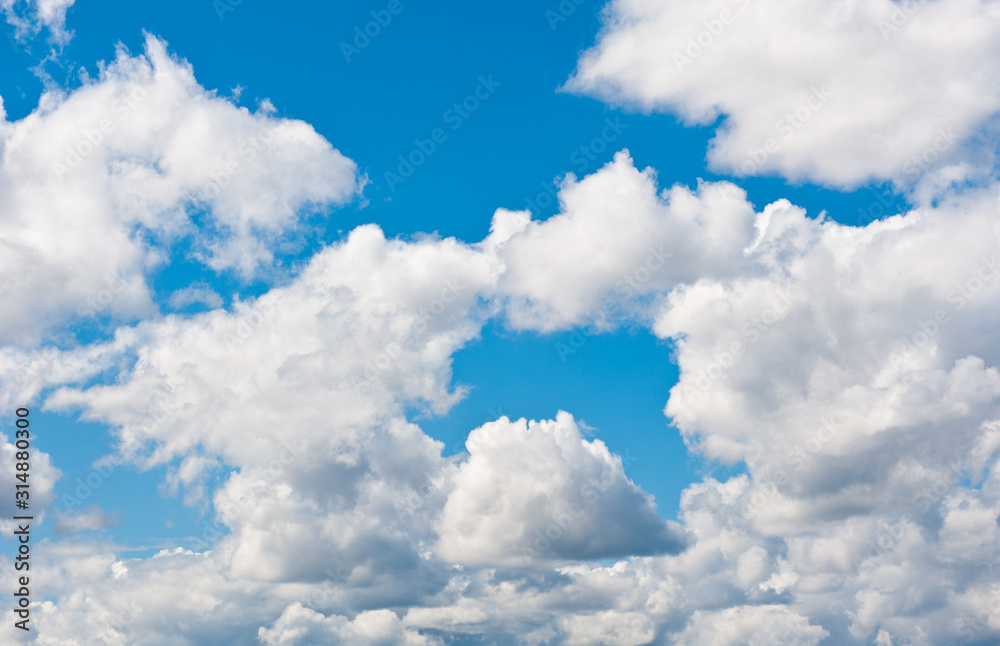Obraz premium large fluffy white clouds in blue sky
