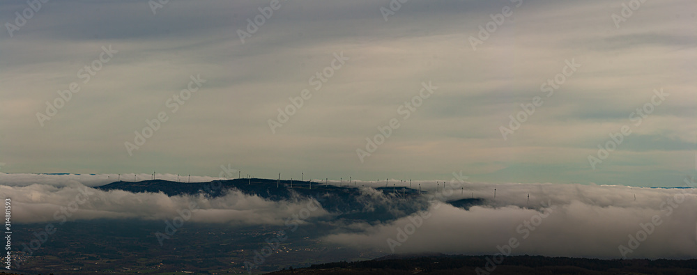 Panoramic image of a mountain range full of wind turbines