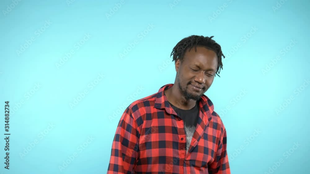 portrait of a stylish handsome African guy on blue background portrait of a stylish handsome African guy on blue background