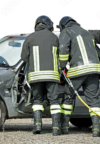 brave firefighters who open the destroyed door of a car using a