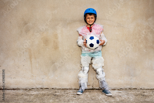Child hold soccer ball overprotecting bubble wrap
