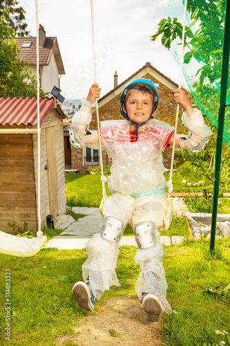 Super safe child in bubble wrap swing on swings photo