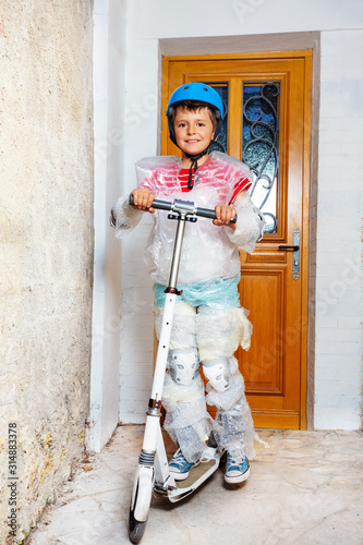 Boy with kick scooter bubble wrap overprotective photo