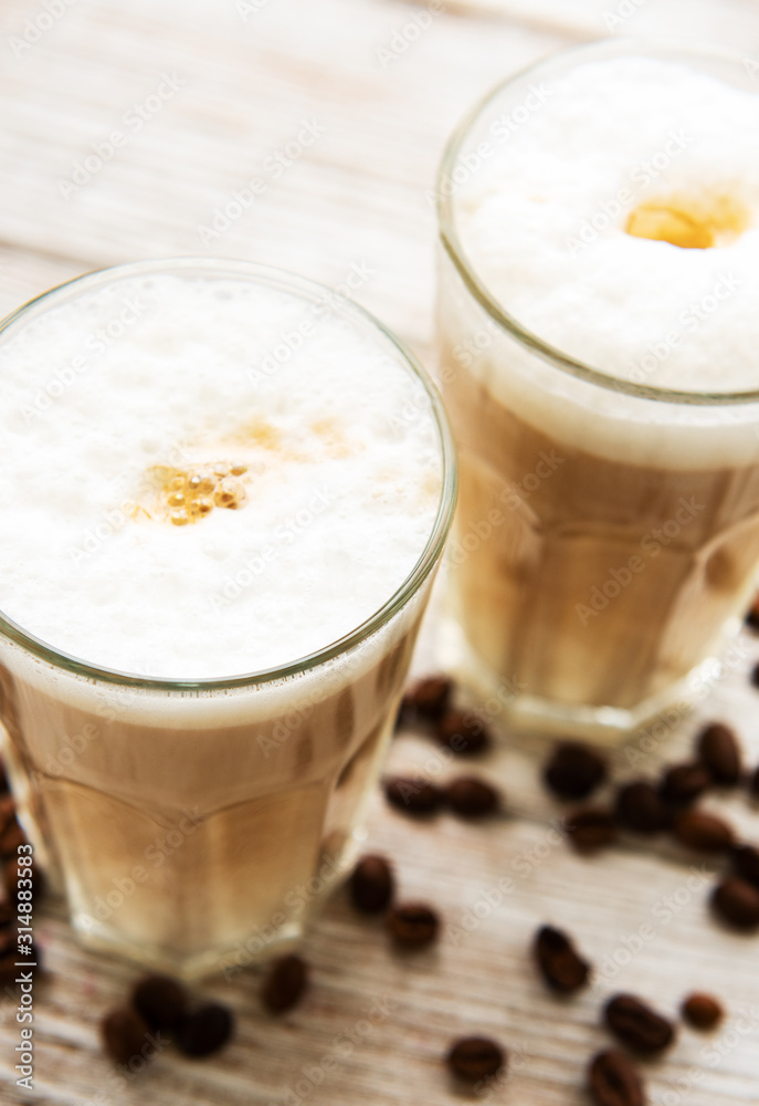 Two glasses of latte coffee and coffee beans Two glasses of latte coffee and coffee beans