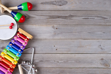 music accessories for children on wooden background. top view.