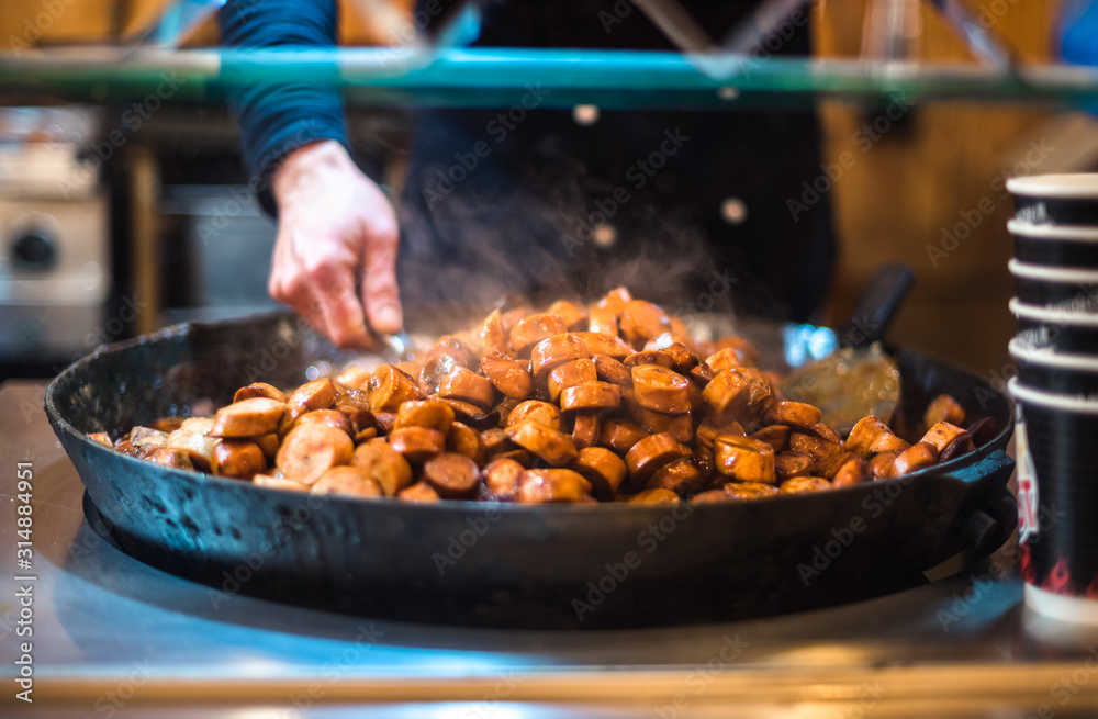 Christmas market uk manchester festival night winter holiday decoration people food weiner wurst delicious steam hot fried pan