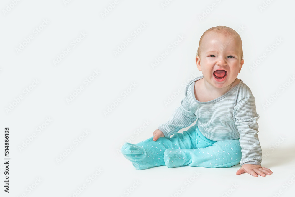 Portrait of baby boy sitting on white background and laughing with open mouth at the camera. Portrait of baby boy sitting on white background and laughing with open mouth at the camera.