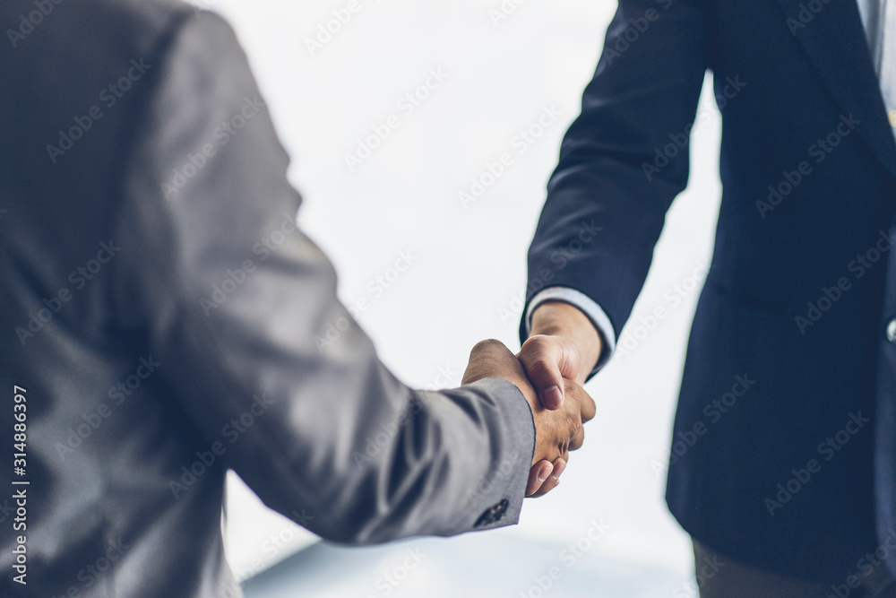 Business people shaking hands at the office. Success teamwork, partnership and handshake business concept