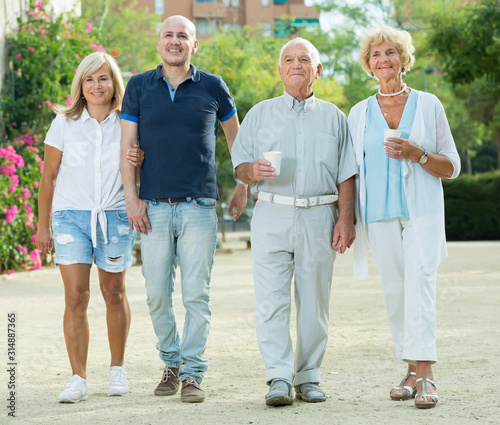 positive elderly friends walking outdoor © JackF