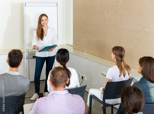 Female business coach communicating with auditorium