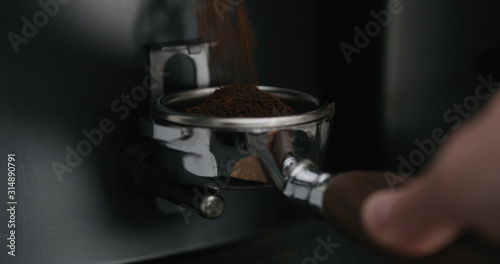 Grinding coffee into naked portafilter