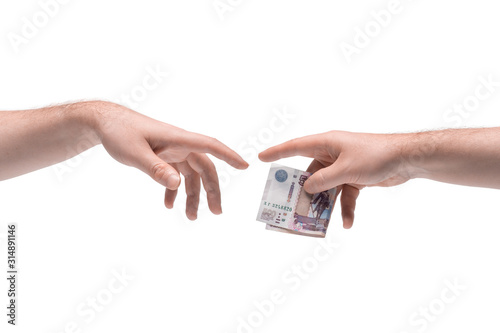 Two male hands passing one another money on white background