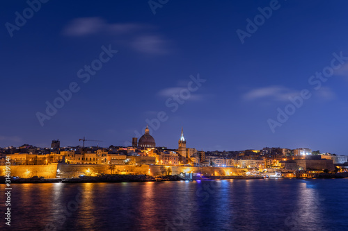 City of Valletta at evening twilight, capital of Malta skyline from the sea
