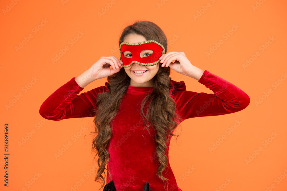 Winter carnival. Incognito mode. Kid wear eye mask. Girl wear mask orange background. Winter event and entertainment. Child development. Visit public event anonymously. Winter new year party Winter carnival. Incognito mode. Kid wear eye mask. Girl wear mask orange background. Winter event and entertainment. Child development. Visit public event anonymously. Winter new year party