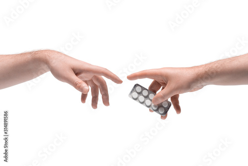Two male hands passing one another pills package on white background (ID: 314891586)