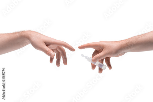 Two male hands passing one another small plastic phial with clear liquid on white background (ID: 314891774)