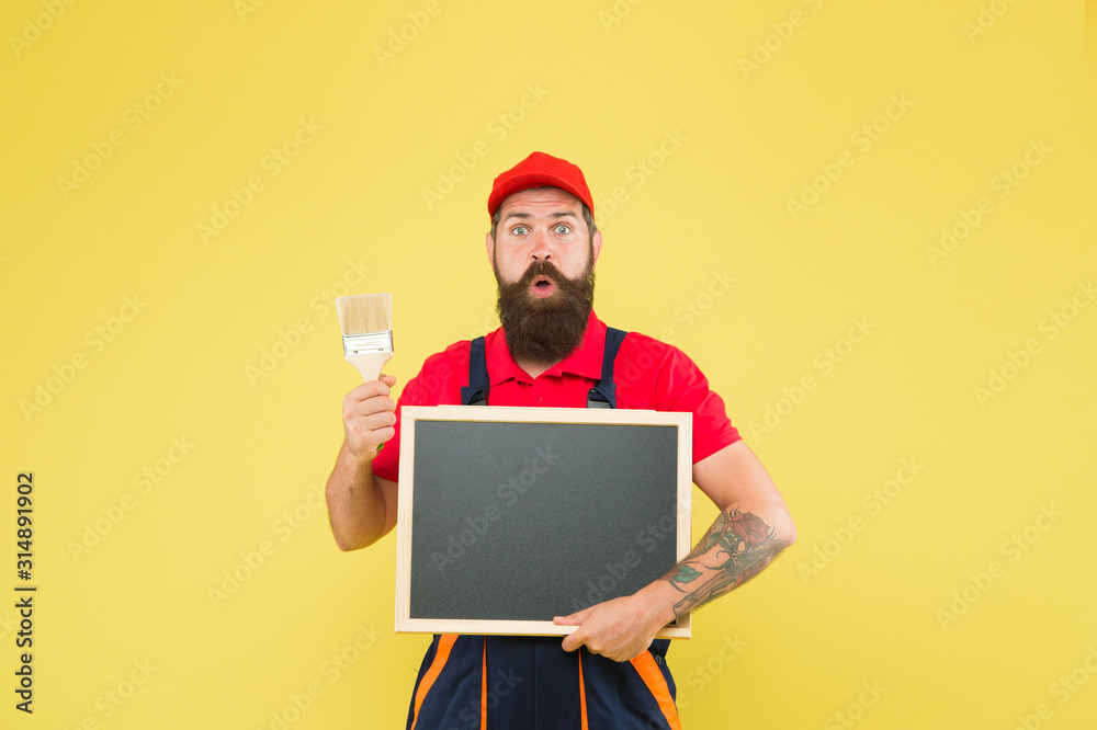 Picky inspector. builder man paint on blackboard. bearded worker painting brush. brutal builder man start own business. announcement and advertisement. copy space. professional repairer wanted