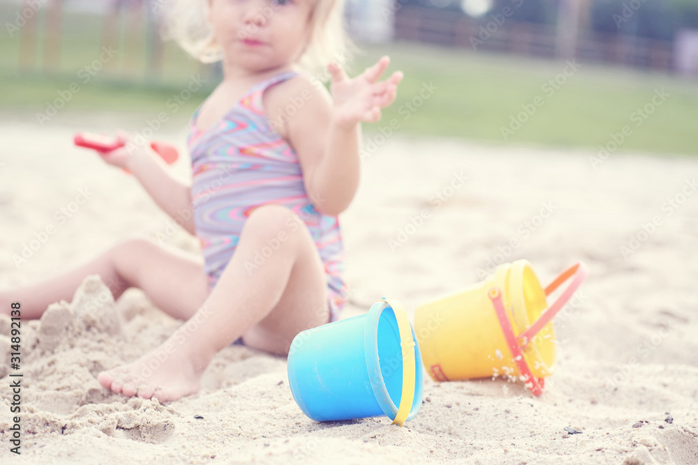 Cute little girl playing on the beach. Summer vacation concept. Cute little girl playing on the beach. Summer vacation concept.