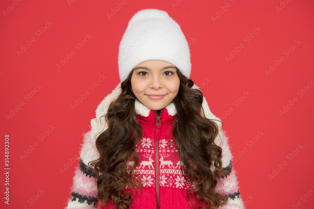winter fashion. portrait of pure beauty. small girl long curly hair. winter holidays began. winter activity for kids. happy childhood. cheerful child in knitted hat. feeling cosy in warm clothes winter fashion. portrait of pure beauty. small girl long curly hair. winter holidays began. winter activity for kids. happy childhood. cheerful child in knitted hat. feeling cosy in warm clothes