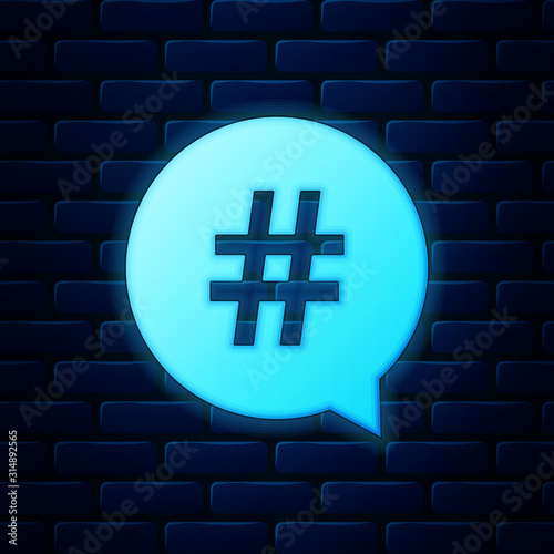 Glowing neon Hashtag in circle icon isolated on brick wall background. Social media symbol, concept of number sign, social media, micro blogging pr popularity. Vector Illustration