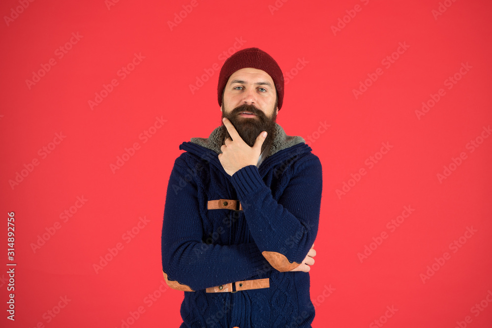 Winter menswear. Man bearded warm jumper and hat red background. Winter season menswear. Personal stylist. Warm and comfortable. Fashion menswear shop. Masculine clothes concept. Think and decide Winter menswear. Man bearded warm jumper and hat red background. Winter season menswear. Personal stylist. Warm and comfortable. Fashion menswear shop. Masculine clothes concept. Think and decide
