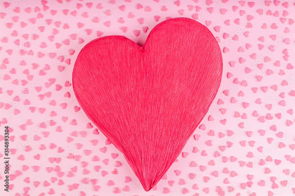 Red Heart Decoration with Small Hearts on a Pink Background. Concept of Valentines Day Celebration 
