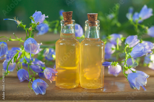 Essence of flowers on table in beautiful glass jar