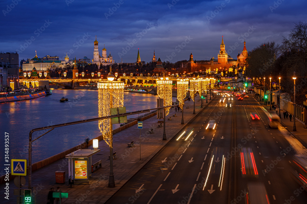 Obraz premium High and wide angle night winter view of the traffic light tails toward Moscow Kremlin, Russia. Travel destination Moscow, Russia