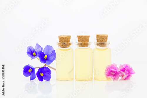violet essential oil in beautiful bottle on White background