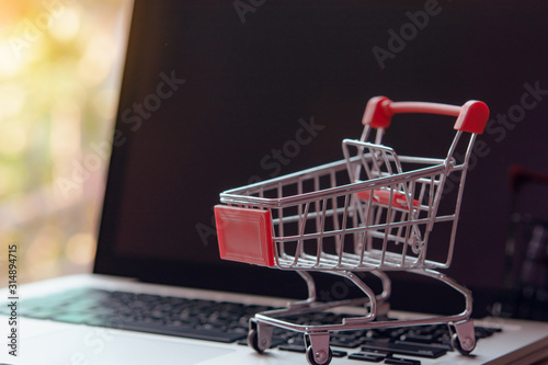 Shopping online concept - Empty shopping cart or trolley on a laptop keyboard. Shopping service on The online web. offers home delivery..