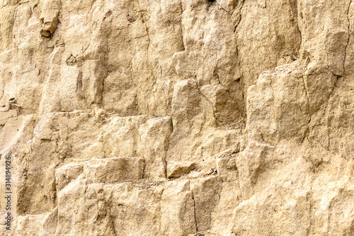 sandstone and clay wall covered with erosion and cracks